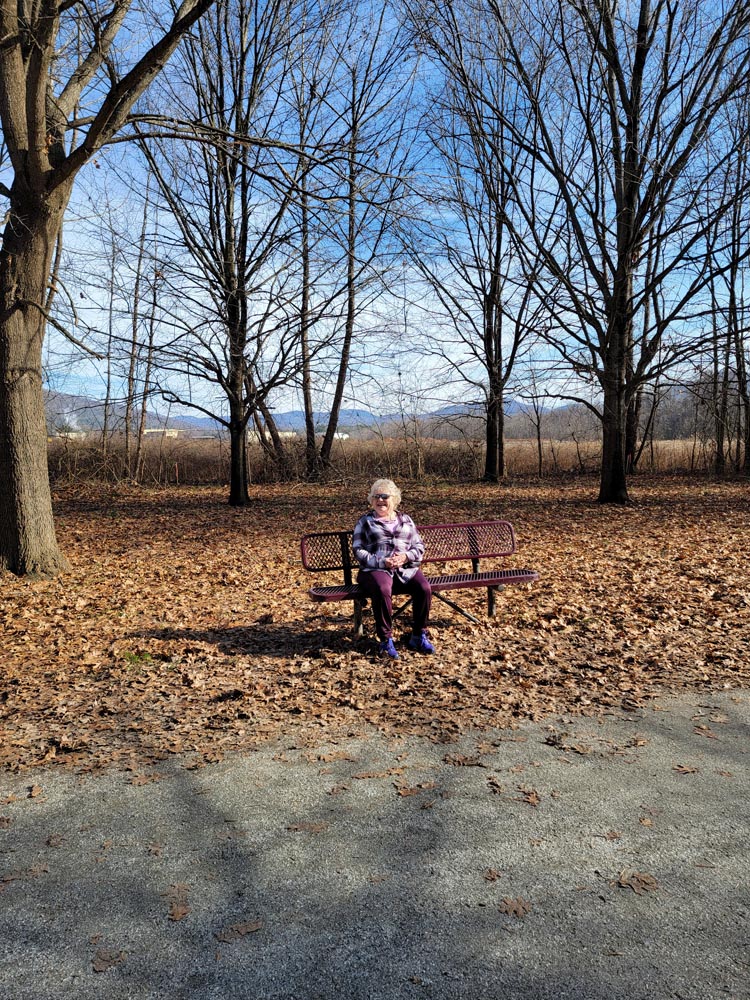 My adorable mom taking a break while hiking, and matching the picnic bench