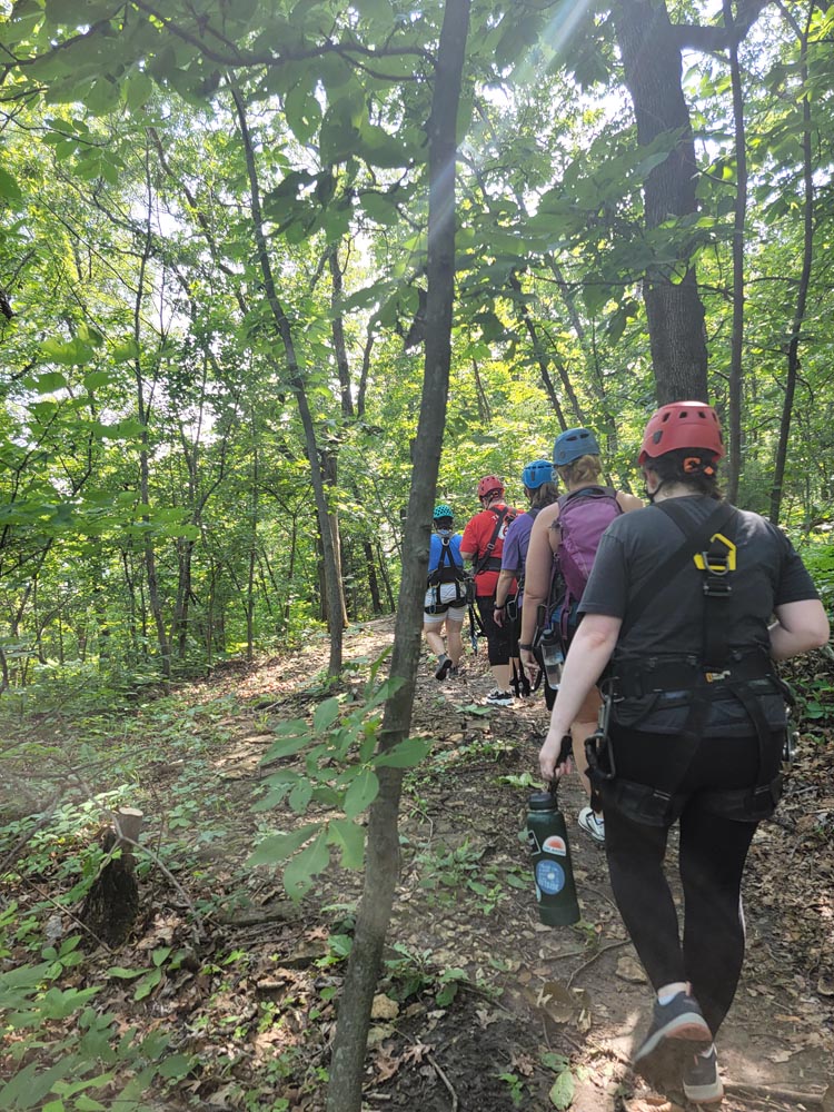 Hiking in the woods to go ziplining in Kansas City