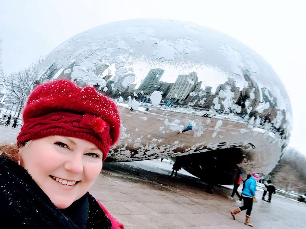 Theresa Goodrich at Cloud Gate in Millennium Park, which is dotted with snow.